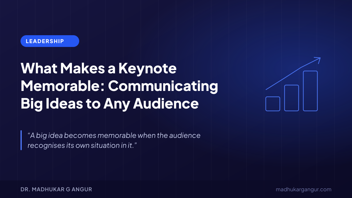 A keynote speaker on a conference stage addressing an attentive audience of educators and professionals